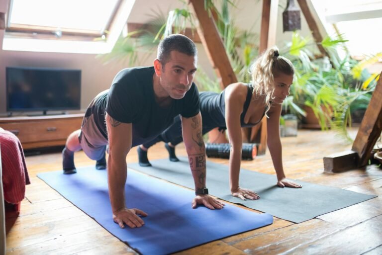 Man and woman doing yoga together at home, emphasizing fitness and healthy lifestyle.